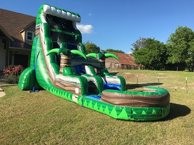 22' Water slide in a front yard. Water slide shaped like a wave with two palm trees in the middle of the slide and a pool at the end. 